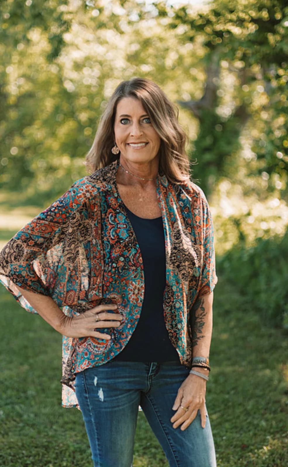 Kandace Cain standing outdoors in a field